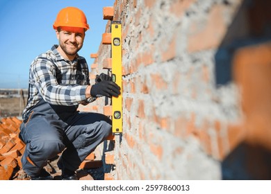 Bricklayer Using a Spirit Level to Check New Red Brick Wall Outdoor. Bricklaying Basics Masonry Techniques.
