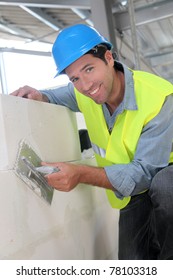 Bricklayer at work on construction site
