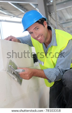 Bricklayer at work on construction site