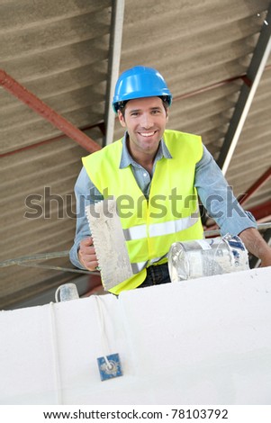 Bricklayer at work on construction site