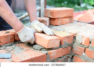 Bricklaying House Wall,  Masonry. Bricklayer Hands In Masonry Gloves Bricklaying House Wall. 