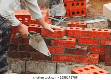 Bricklaying in progress at a construction site during daylight hours, showcasing skilled craftsmanship and materials - Powered by Shutterstock