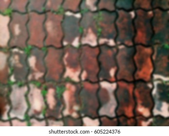 Bricklaying worm. Top view of paving block texture. Blurred background. 