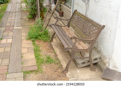 Brick-paved Alleyway With Benches On The Side Of The Road