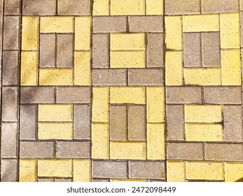 Bricks are like tiles on a path or sidewalk. Background, texture. A decorative brick path leads past a row of parked cars