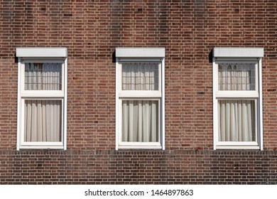 Bricks wall background with three windows, Abstract geometric pattern, Old brown block texture, Outdoor building wall, Can be used as background for display or montage your products.