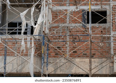 Bricks wall and cement background.Scaffolding and bricks wall on work site.Empty construction site.Red grunge brick wall texture.Empty construction site. - Powered by Shutterstock