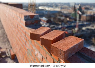 Brickwork in the new house with three bricks in the foreground