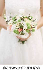 Bridal bouquet. Beautiful bouquet of different colors in the hands of the bride