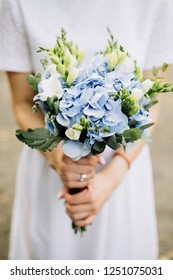 blue hydrangea and white rose boutonniere