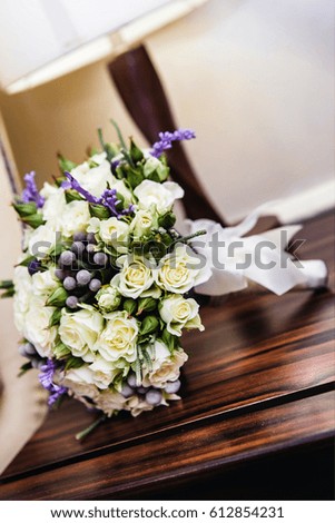 A bridal bouquet lies on a table