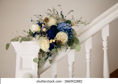 Bridal Bouquet Propped Up On White Stair Bannister