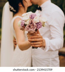 Bridal bouquet of violet and white roses, as well as heleny eucalyptus leaves. Wedding, holiday - Shutterstock ID 2139415709