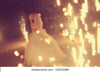 Bridal couple dancing sorrounding by fireworks