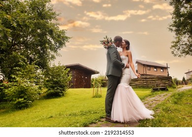 Bridal Couple Happy Newlywed Woman And Man Walk In Green Park Or Forested. Bride And Groom Irish Style At Wedding Day Outdoors On In Country Village House. Concept Of Marriage Day And Married