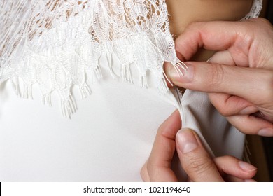 Bridal Gown Fitting. Seamstress Prepares Dress To The Fitting.