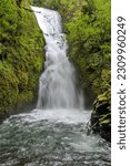 Bridal Veil Falls - A vertical full view of roaring Bridal Veil Falls on a stormy Spring day. Columbia River Gorge, Oregon, USA.