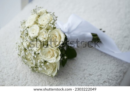 Bridal wedding bouquet lying on modern brown sofa at home photo session studio. Stunning green white flowers roses wildflowers. Engagement between two lovoer people. Image with copy space.

 Photo stock © 