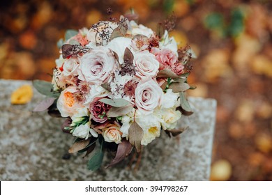 Bridal  Wedding Bouquet On Autumn Foliage Background, Outdoor