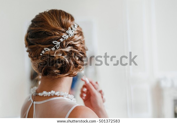 Bridal wedding\
hairstyle with jewelry\
wreath
