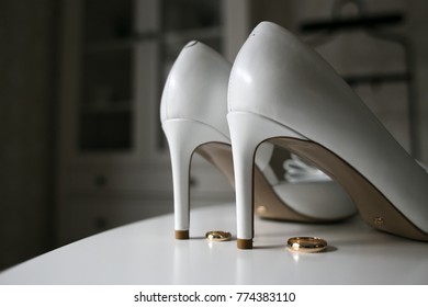 Bridal wedding shoes and 
wedding rings - Shutterstock ID 774383110