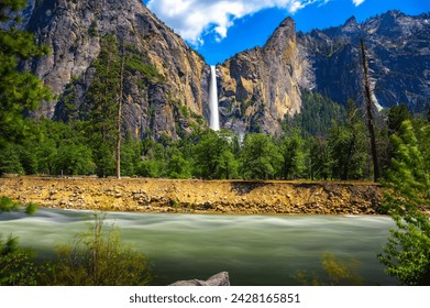 Bridalveil Fall cascading into Yosemite Valley with the Merced River in the foreground in Yosemite National Park, California. Long Exposure. - Powered by Shutterstock