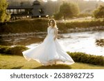 bride against the background of a yellow sunset on a pier near the river