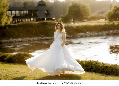 bride against the background of a yellow sunset on a pier near the river