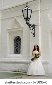 Bride Alone, Standing Under A Street Lamp