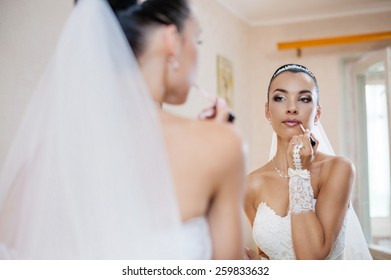 Bride applying make-up - Powered by Shutterstock