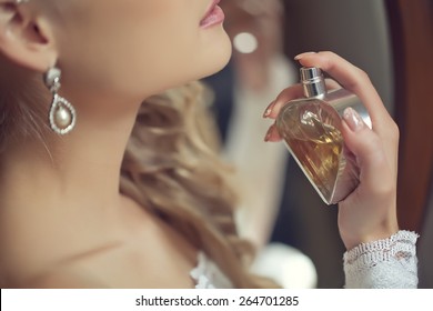 bride applying perfume 
