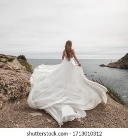 Bride in a beautiful wedding dress at the sea