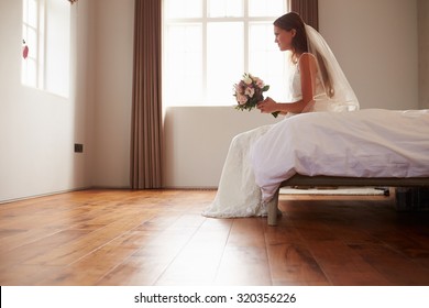 Bride In Bedroom Having Second Thoughts Before Wedding