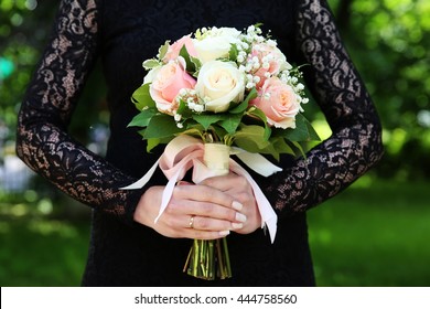 Bride In Black Wedding Dress With Wedding Bouquet In Her Hands