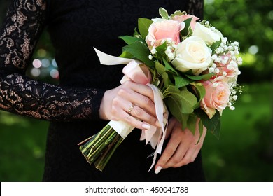 Bride In Black Wedding Dress With Wedding Bouquet In Her Hands