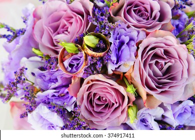 Bride Bouquet Of Purple Flowers  With Wedding Gold Rings