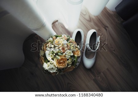 bride bouquet and shoes on the floor, curtained, parquet floor
