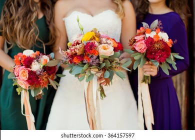 Bride And Bridesmaids With Autumn Bouquets