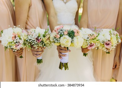 Bride and bridesmaids hand with beautiful flowers