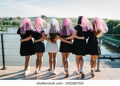 Bride And Bridesmaids Stands Back On A Beach And Celebrating Bachelorette Party. Beautiful Sexy Young Girls In Dress And Veil On Bachelor Party. Maiden Evening, Hen-parties. Close Up. Place For Text.