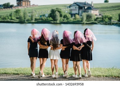 Bride And Bridesmaids Stands Back On A Beach And Celebrating Bachelorette Party. Beautiful Sexy Young Girls In Dress And Veil On Bachelor Party. Maiden Evening, Hen-parties. Close Up. Place For Text.