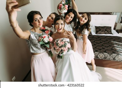 Bride and bridesmaids are taking a selfie