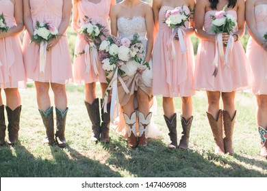 Bride and Bridesmaids wearing cowboy boots, blush pink bridal dresses, white and pink peonies bouquet, southern wedding style