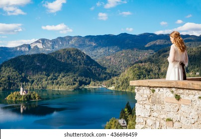 Bride in a castle looking at Lake Bled, Slovenia