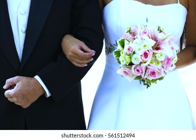 Bride And Father Arm In Arm