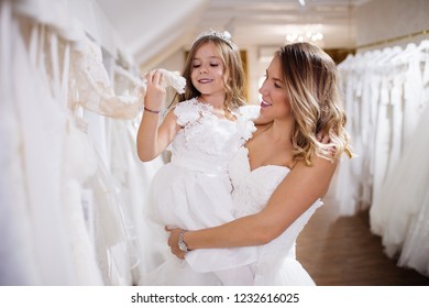 Bride With Flower Child Or Bridesmaid Preparing For Wedding.