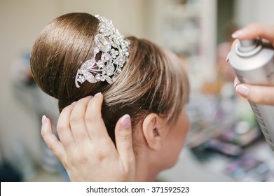 bride get a professional hair style at beauty salon