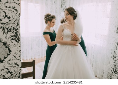 A bride is getting ready for her wedding with the help of her bridesmaids. The bride is wearing a white dress and a veil - Powered by Shutterstock