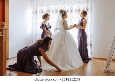 A bride is getting ready for her wedding with the help of her bridesmaids. The bride is wearing a white dress and the bridesmaids are wearing purple dresses. Scene is joyful and celebratory - Powered by Shutterstock