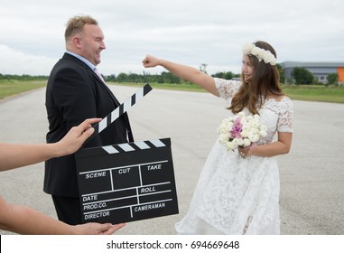 Bride and groom action scene with clapper board 